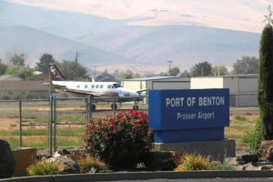 Prosser Airport sign with plane in background